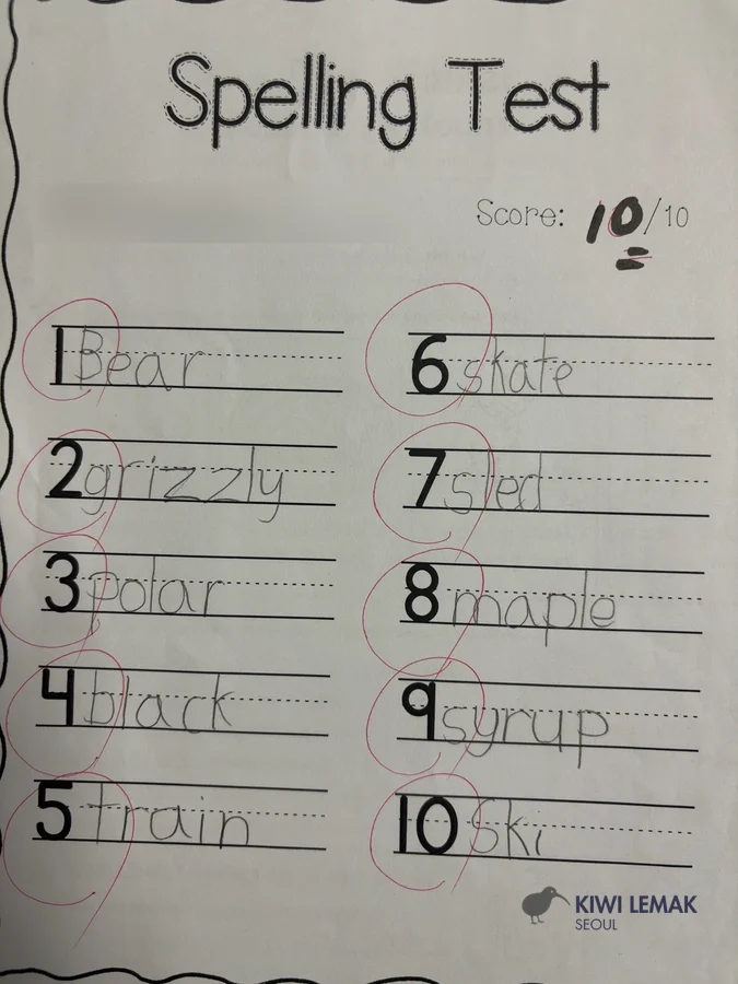 Completed spelling test with a perfect score, name redacted