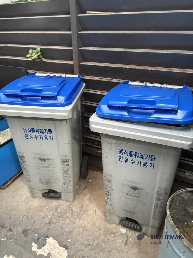 Food waste collection bins with foot pedal in a Korean apartment complex
