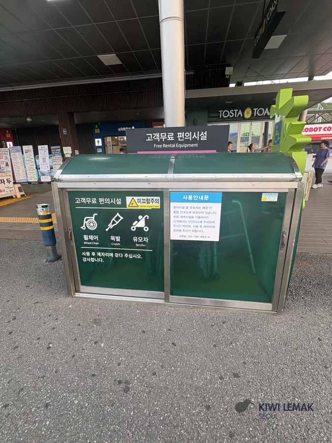 A cabinet of free rental equipment -- wheelchairs, crutches, strollers -- available to any rest stop visitor, marked with accessibility icons.